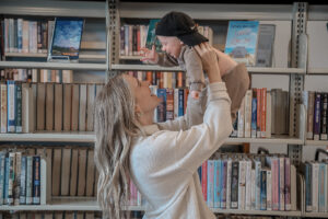 Mom holding her son in the air, smiling at each other