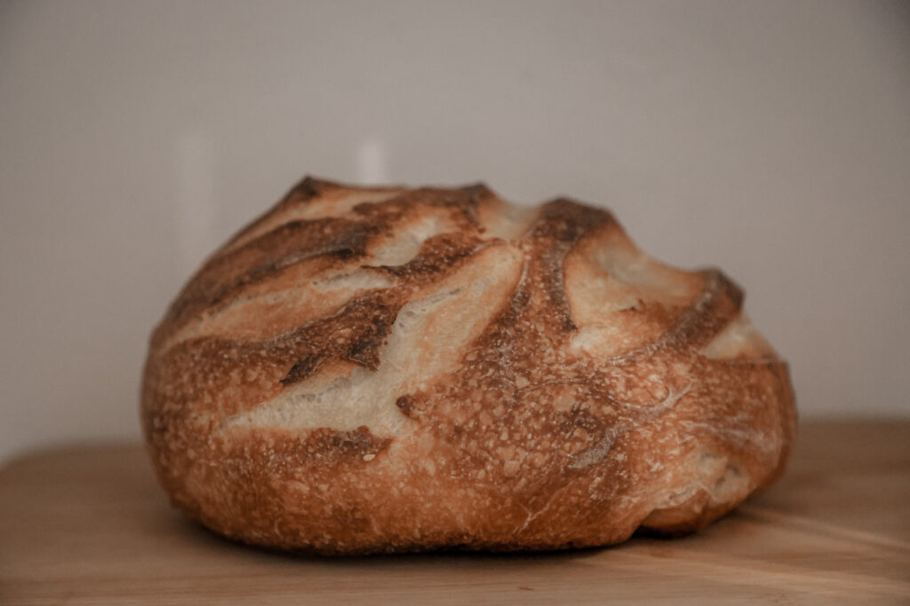 a golden loaf of sour dough bread