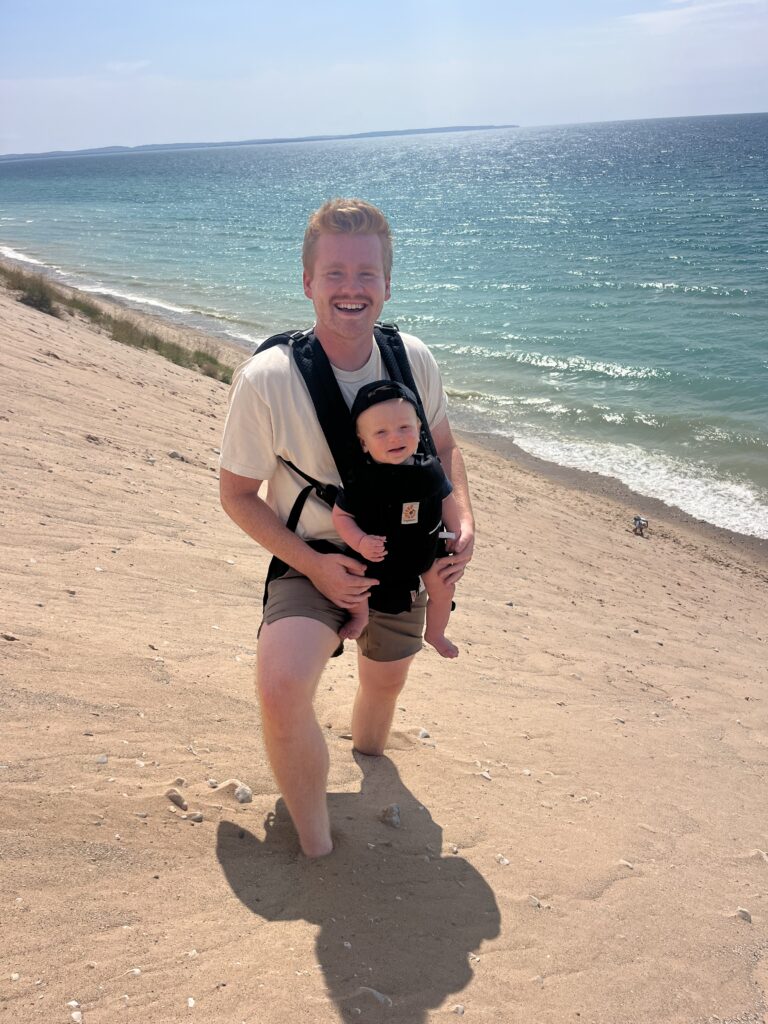 Dad holding son on the beach representing men in your life who would love these gift ideas