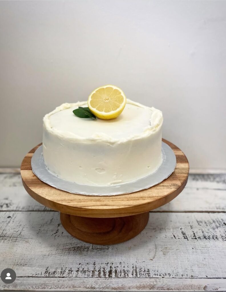 8” round white frosted cake with 1/2 lemon on top