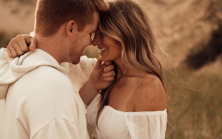 Husband and wife posing looking into each others eyes