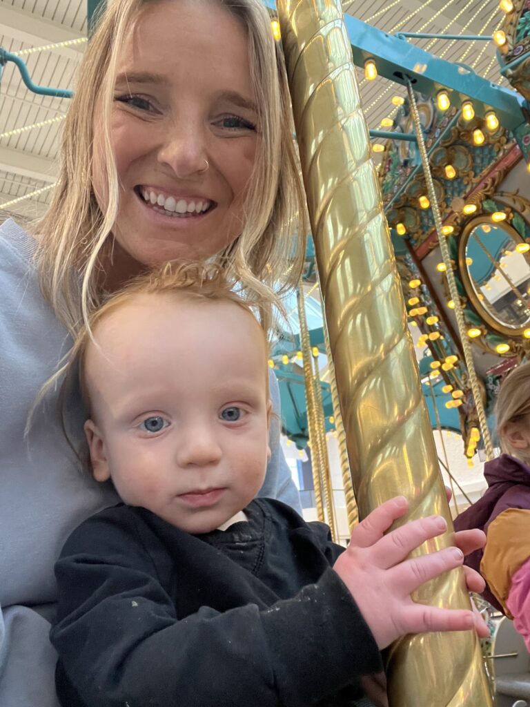 Mom and her 1 year old son on the carousel 