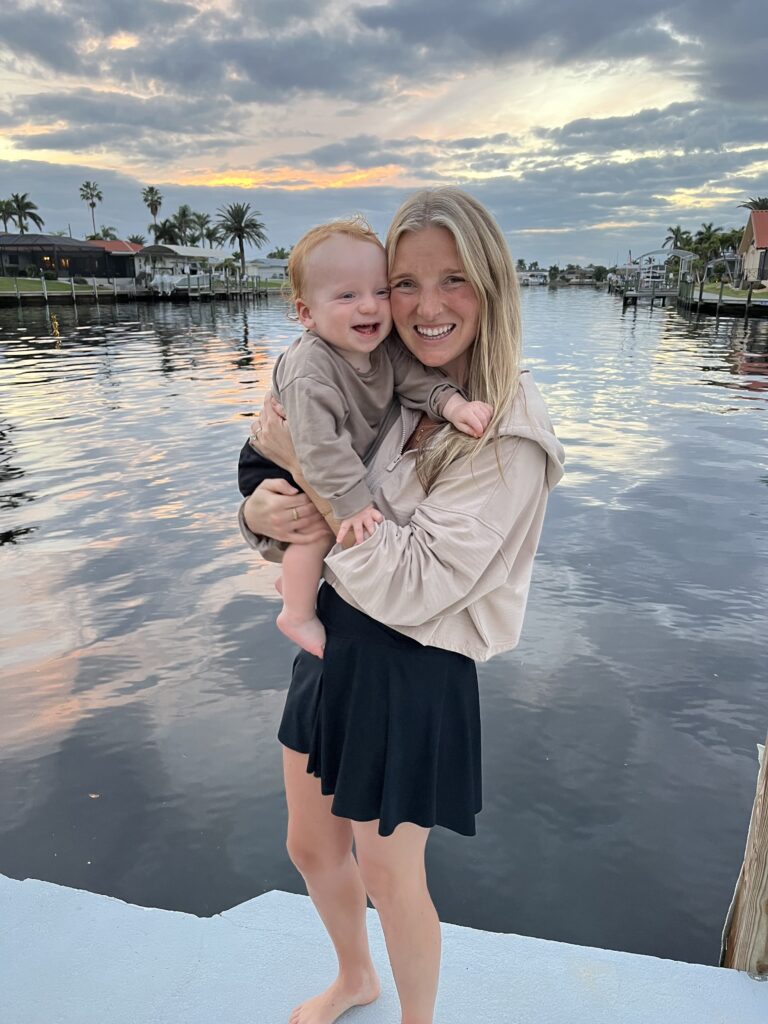 Mom and her one year old son smiling laughing with a beautiful water background